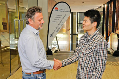 Image of two men shaking hands.